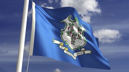 Connecticut flag waving with blue sky background