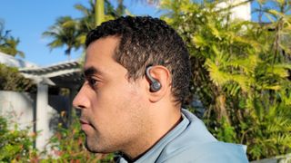 Hero image for the best cheap running headphones showing the JLab Go Air Sport earbuds with earhooks