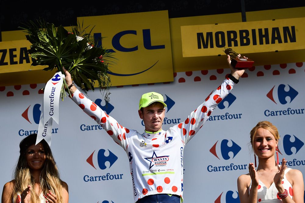 Dion Smith, wearing the best climber's polka dot jersey, celebrates on the podium after the fourth stage of the 105th edition of the Tour de France
