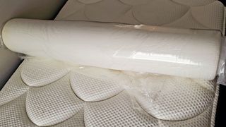 Image shows the Viscosoft Active Cooling Mattress Topper we received for testing still wrapped in its plastic covering