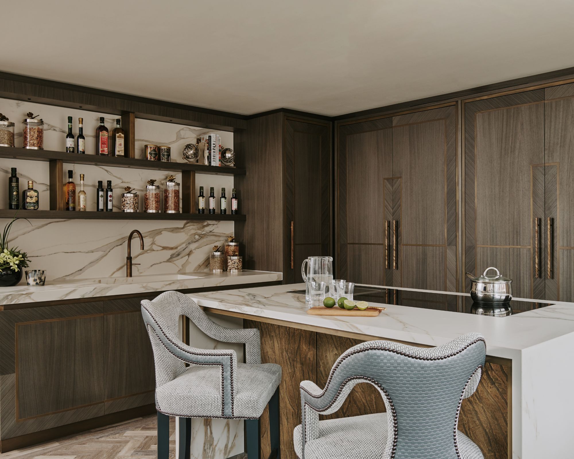Marquetry style cabinets shines in a moody kitchen with luxe marble detailing