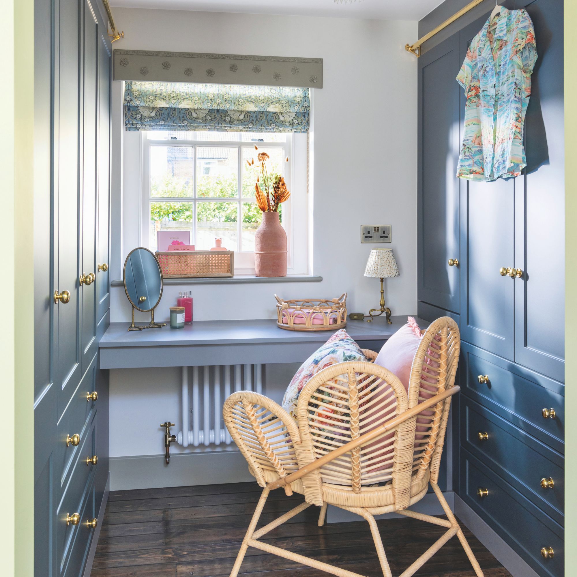 Dressing area with wardrobes, vanity and chair in converted garage