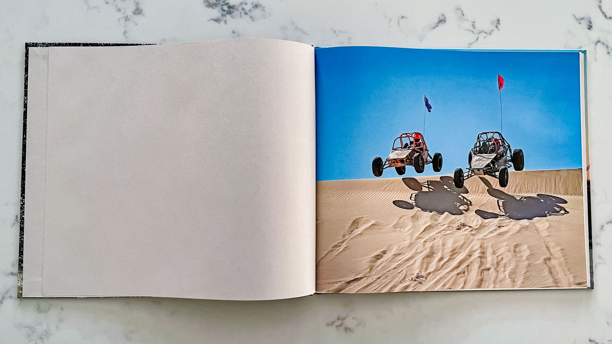 A Blurb photo book open on a countertop surface