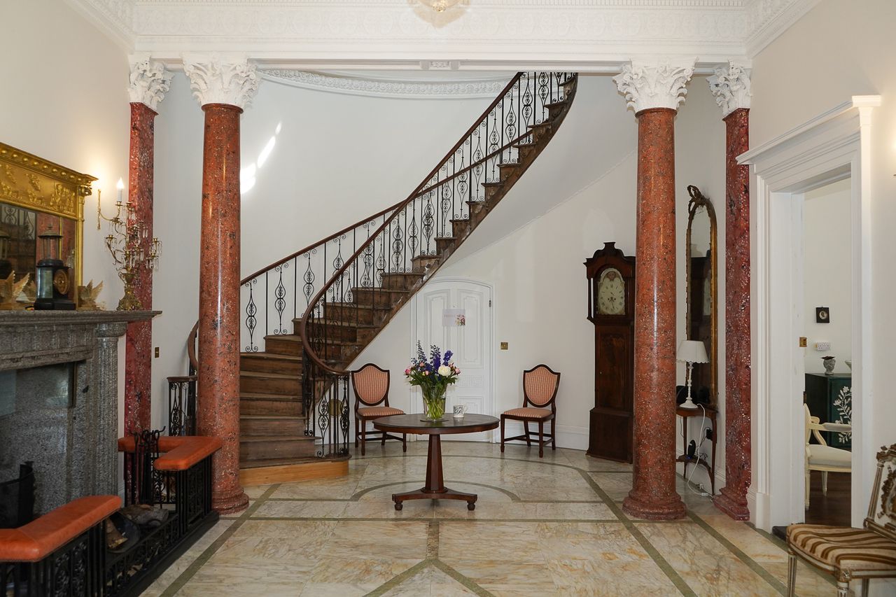 The stunning interior with a curving staircase
