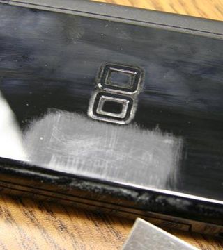 At this point, the DS is covered with fingerprints and scuffs and isn't looking so new anymore. However, we had to prepare a surface on top cover of the DS Lite where the metal latch could be securely attached.