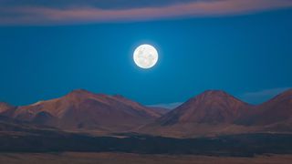 A full moon rises in Chile's Atacama Desert.