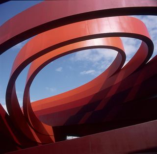 Corten steel forms the red ribs of the building