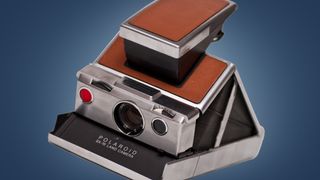 The Polaroid SX-70 camera on a blue background