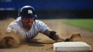 Baseball player sliding towards base