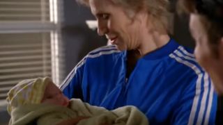 Jane Lynch as Sue Sylvester on Glee holding a baby