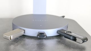 The Satechi Aluminum USB Headphone Stand with USB drives and a microSD card reader inserted into its USB ports