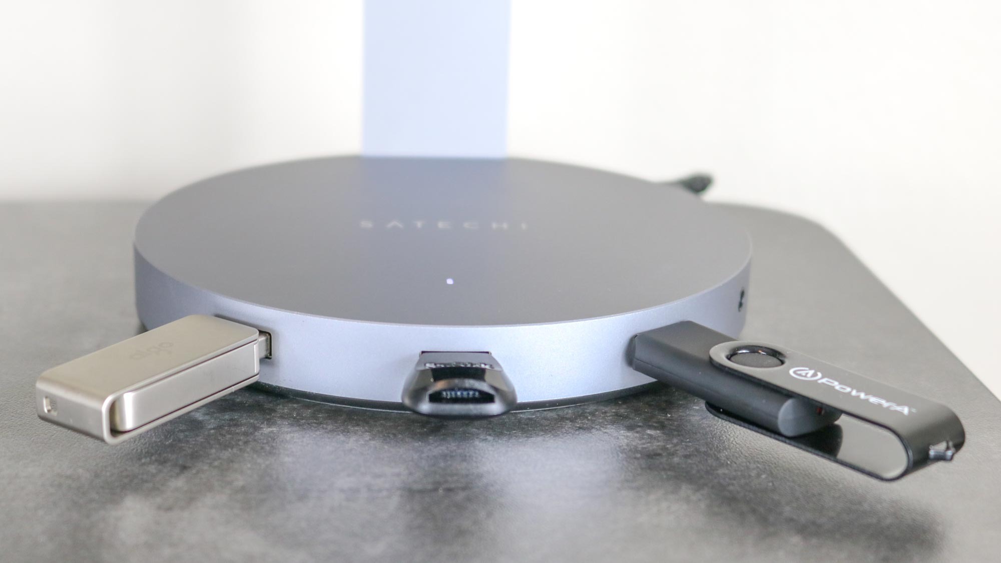 The Satechi aluminum USB headphone stand with USB drives plugged into the USB ports and a microSD card reader