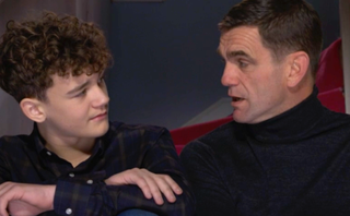 EastEnders Ricky Jr talks to dad Jack on the stairs at home.