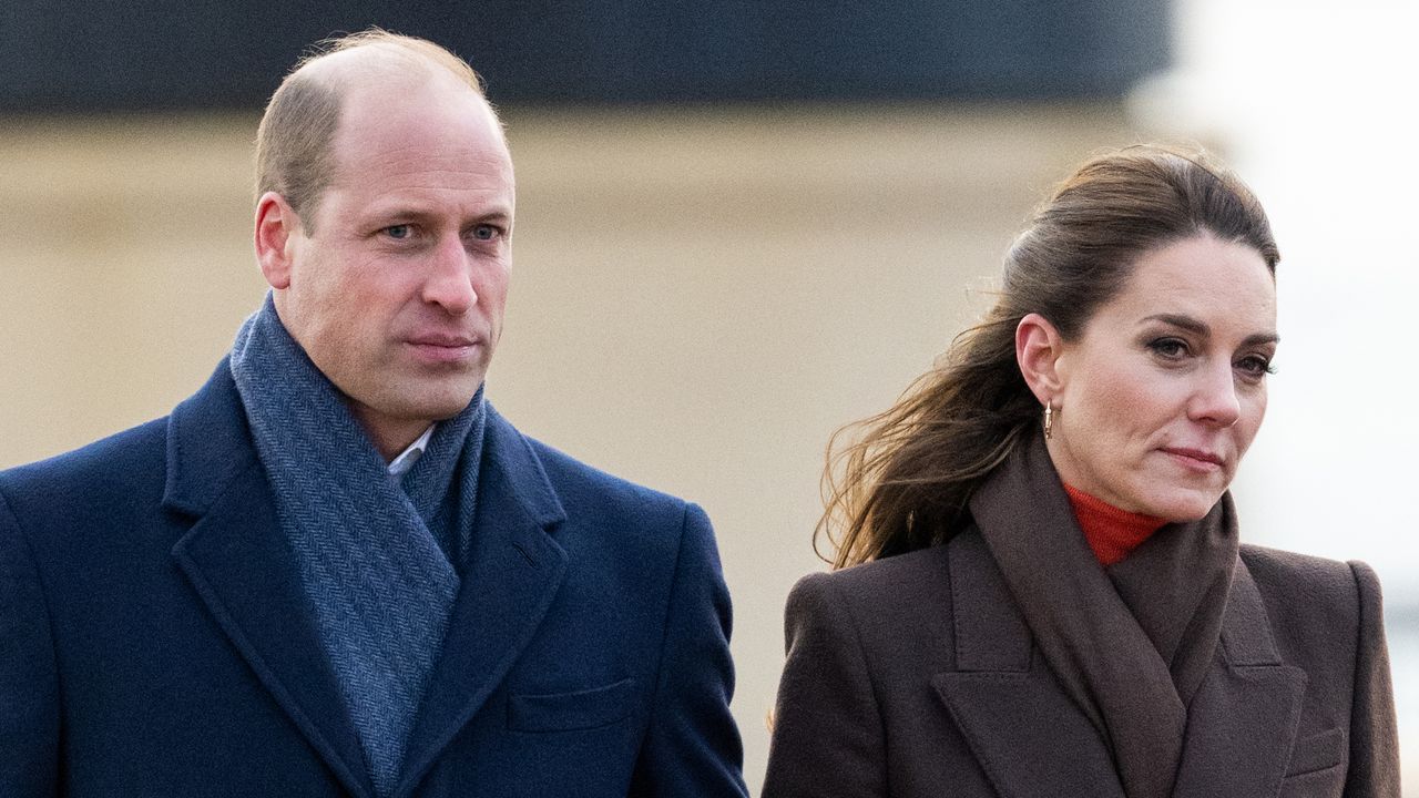 Prince William wears a navy overcoat and blue scarf while Kate Middleton wears a brown coat and matching scarf