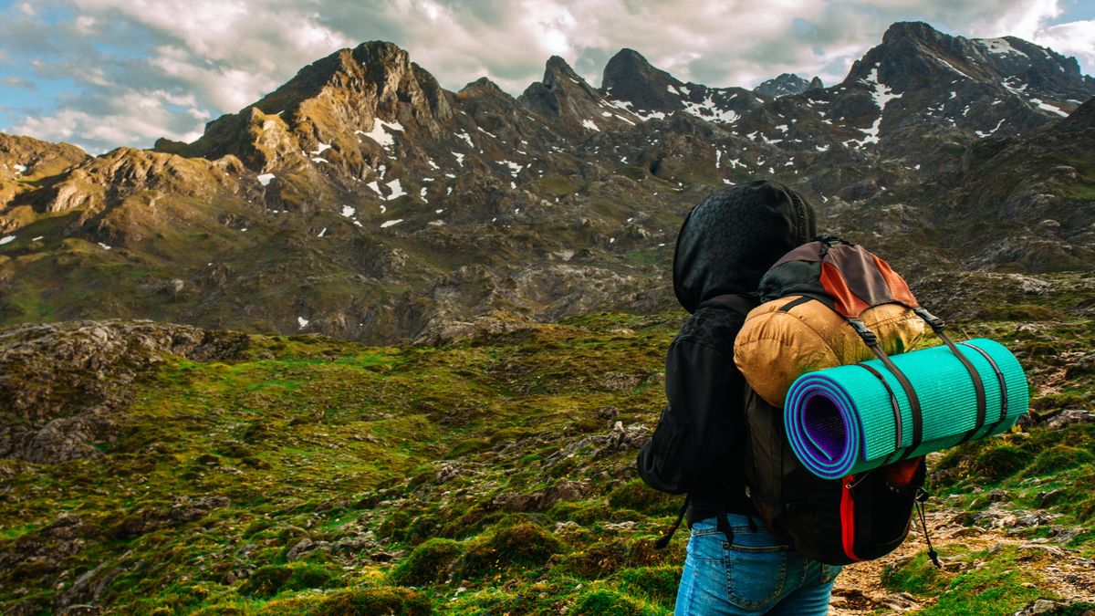 Hiker wearing jeans in rainy weather