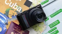 The Panasonic Lumix TZ200 sitting on some maps and travel guides