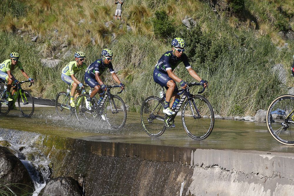 Riders make their way through a wet spot on the course during stage 6.