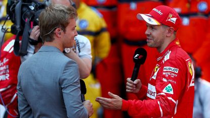 F1 2016 world champion Nico Rosberg talks with Ferrari driver Sebastian Vettel