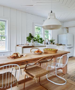 Modern farmhouse kitchen with white cabinets and a wooden farmhouse table
