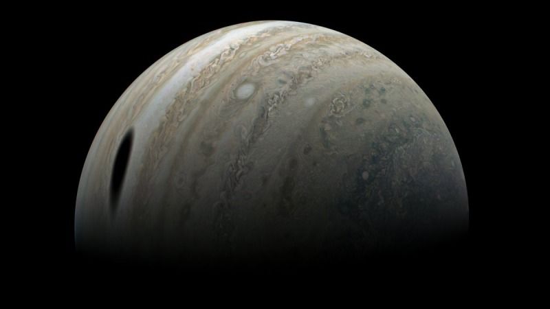 Jupiter and the shadow of its moon Ganymede, in a 2022 image based on a May 2019 flyby of the Juno spacecraft.