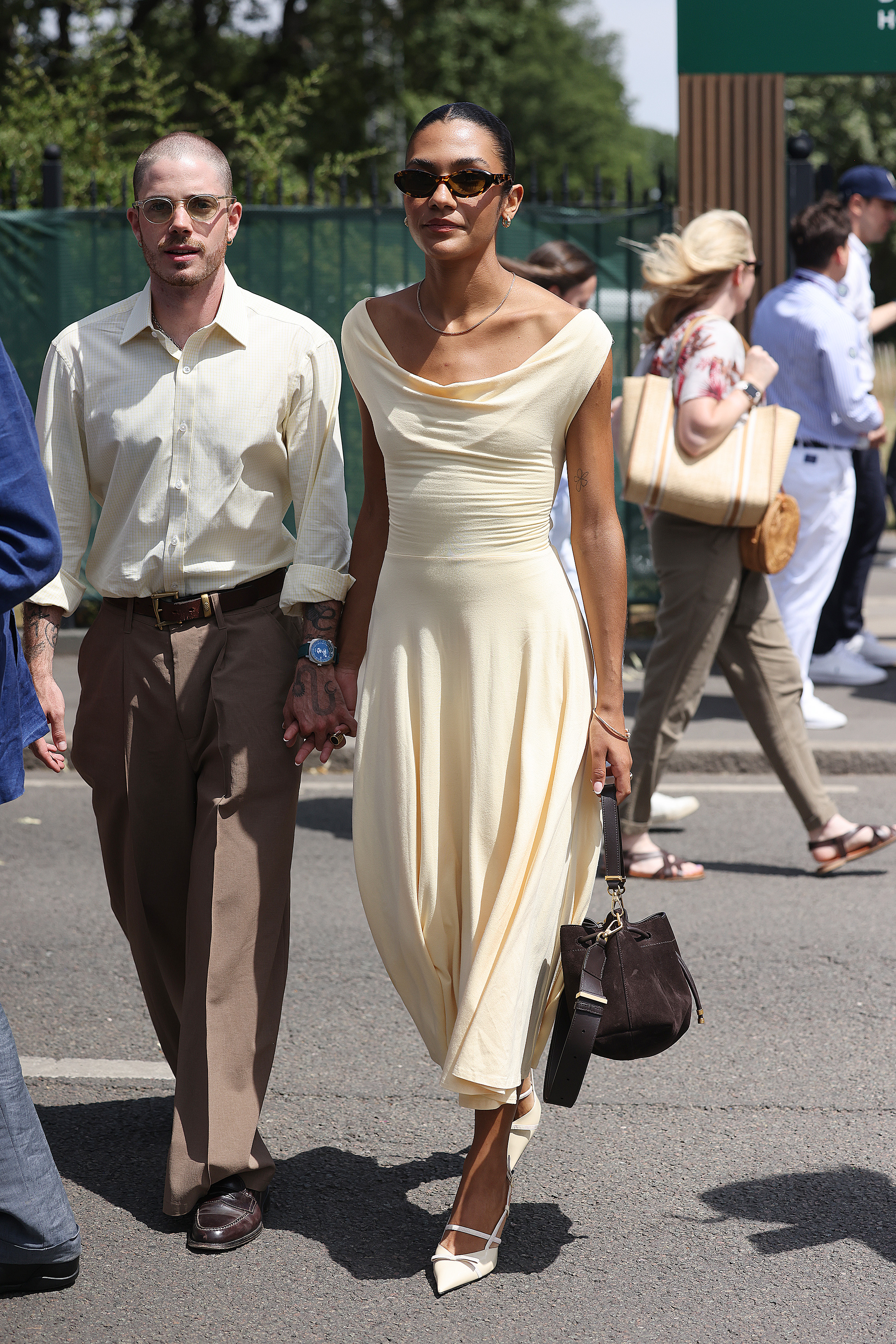 Olivia Dean wore an off the shoulder butter yellow dress at Wimbledon