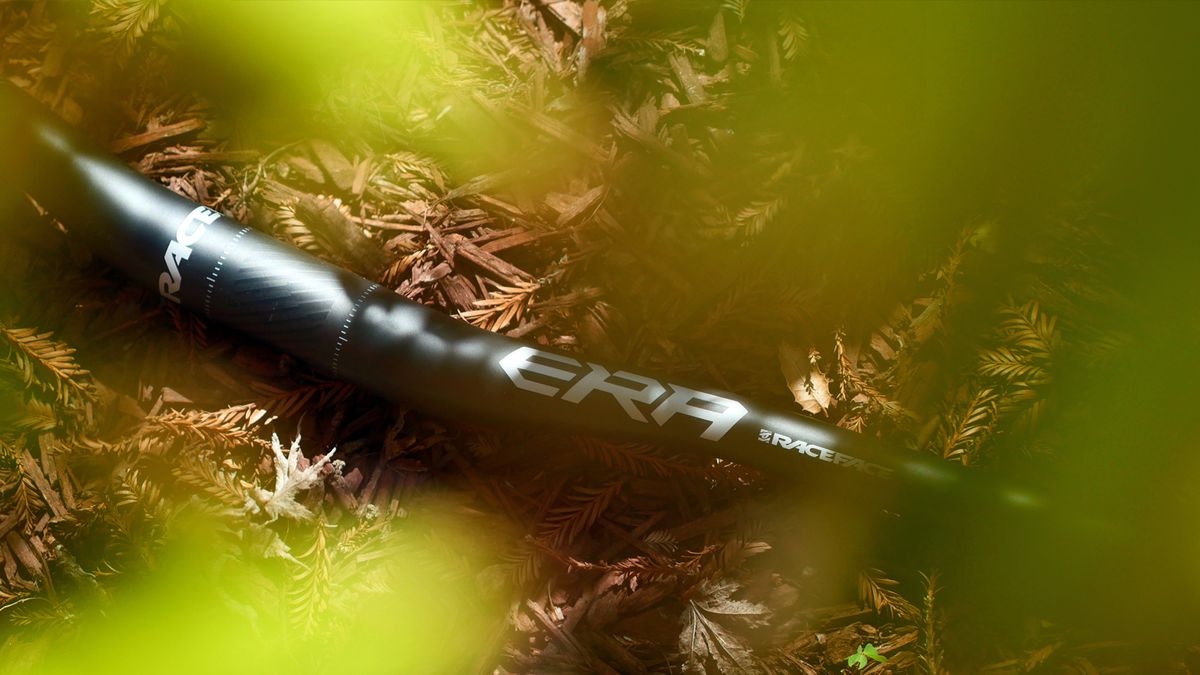 Race Face Era handlebar against a wood chip back drop