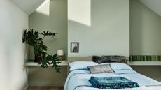 Bedroom with double bed and blue linen with walls in Farrow & Ball’s Mizzle and ceiling in Wimborne White