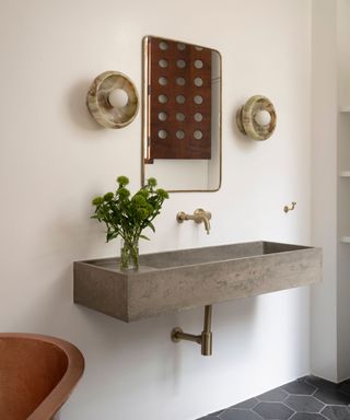 floating stone basin in bathroom with with white walls