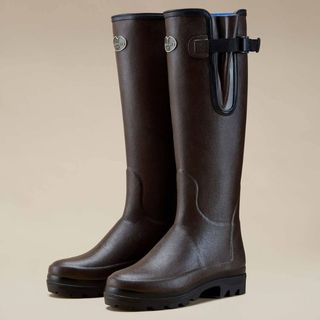 A pair of brown La Chameau wellington boots on a brown background