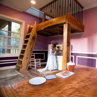room with wooden flooring and purple wall