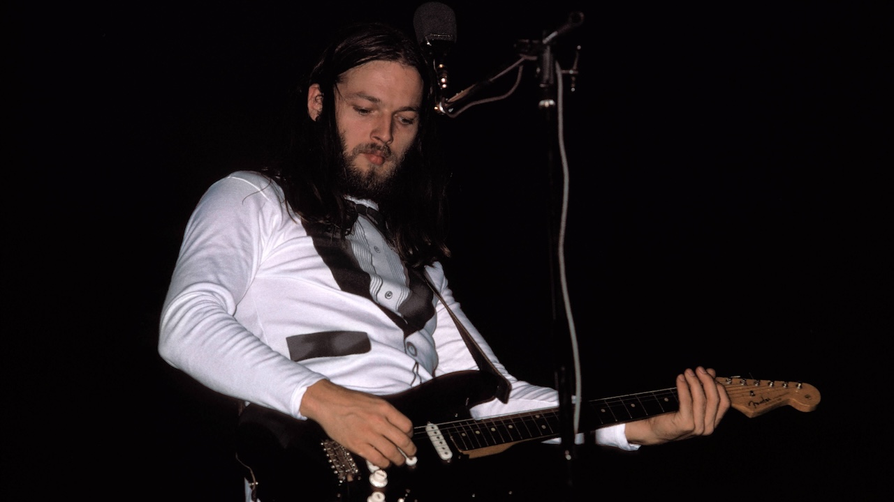 David Gilmour performing live onstage, playing black Fender Stratocaster, on Wish You Were Here tour
