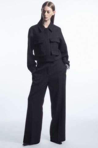 cos sale - woman wearing tailored wool wide leg trousers and short jacket
