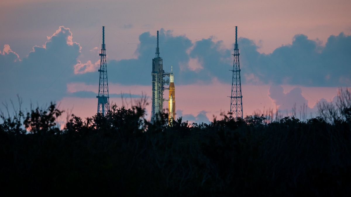 nasa megarocket on launch pad with clouds behind