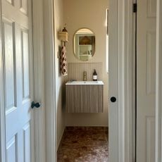 small bathroom with sliding door and wall-hung vanity