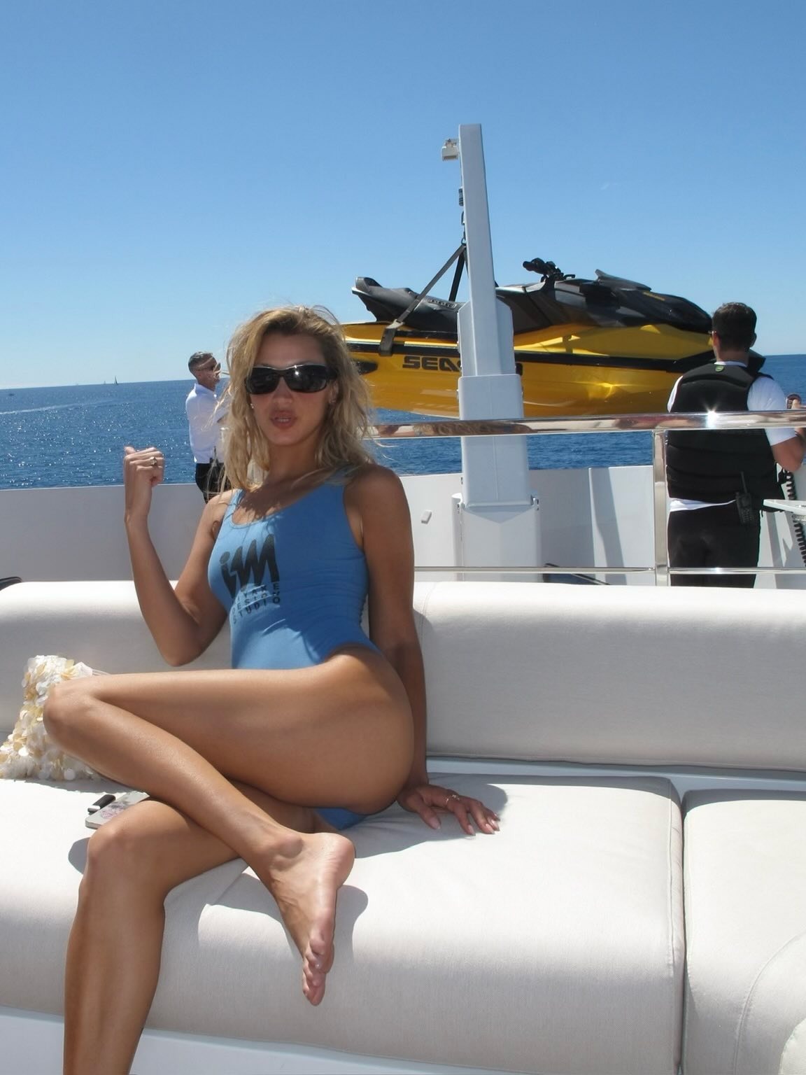 Bella wears a blue one-piece swimsuit.