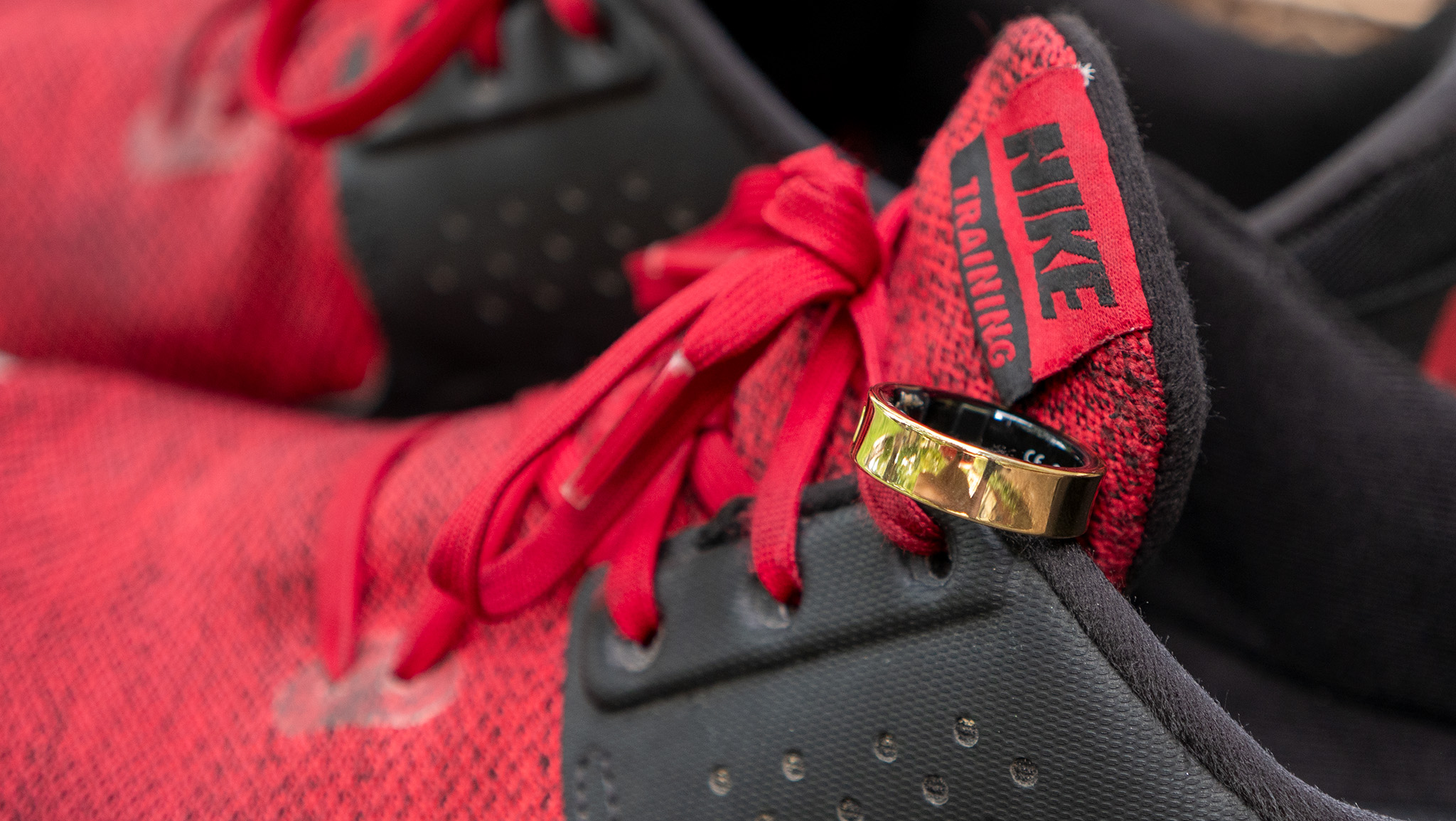 A gold Samsung Galaxy Ring on a red cross trainer Nike shoe