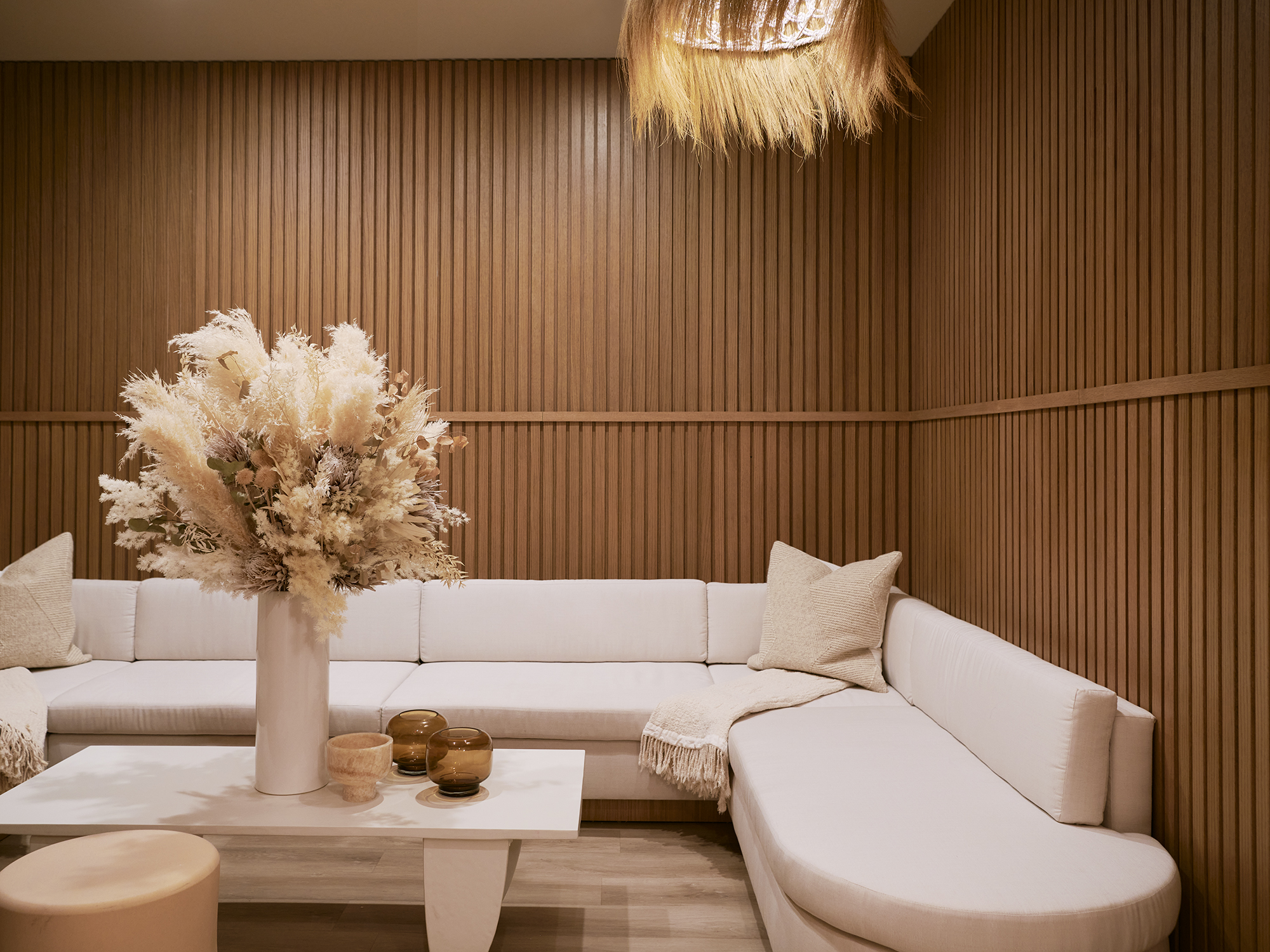 A wooden-clad spa with contemporary creme furnishings in sculptural shapes.