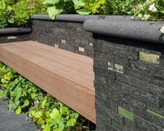wooden bench built into a retaining wall