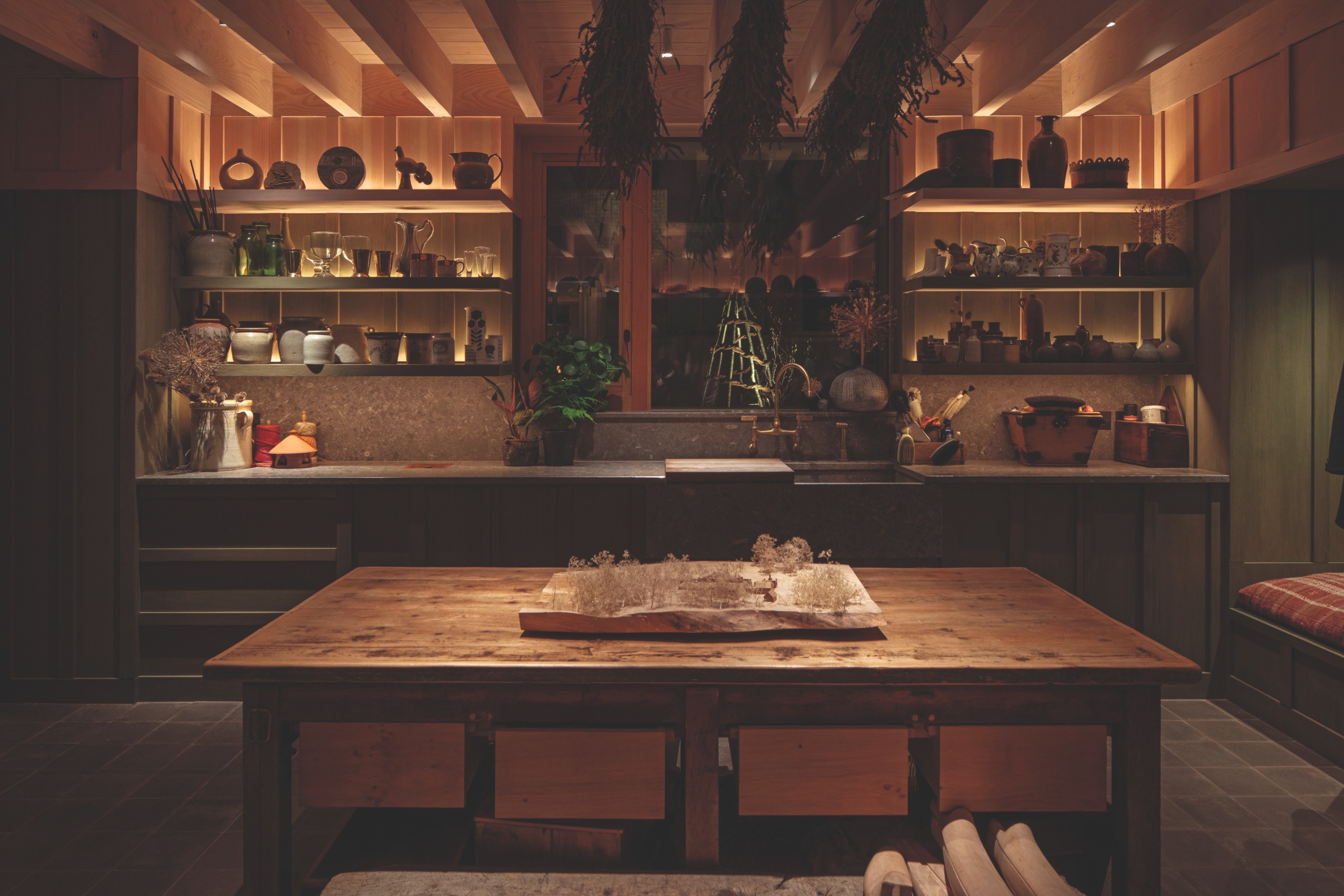 A view of a utility room, with lots of wood, soft colours and up lighting