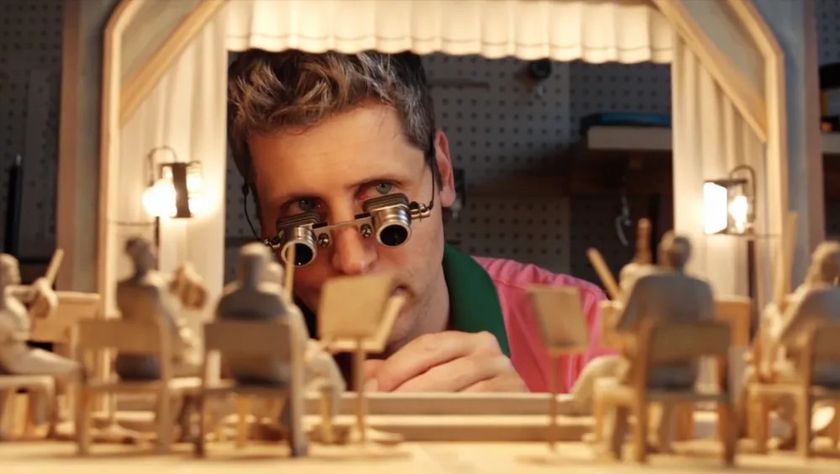 OpenAI CEO Sam Altman looking at models of an audience AI-generated using Sora 2