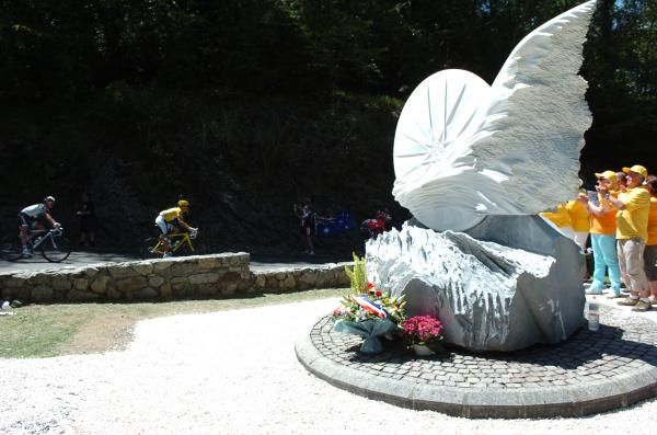 Andy Schleck rides past the Fabio Casartelli monument