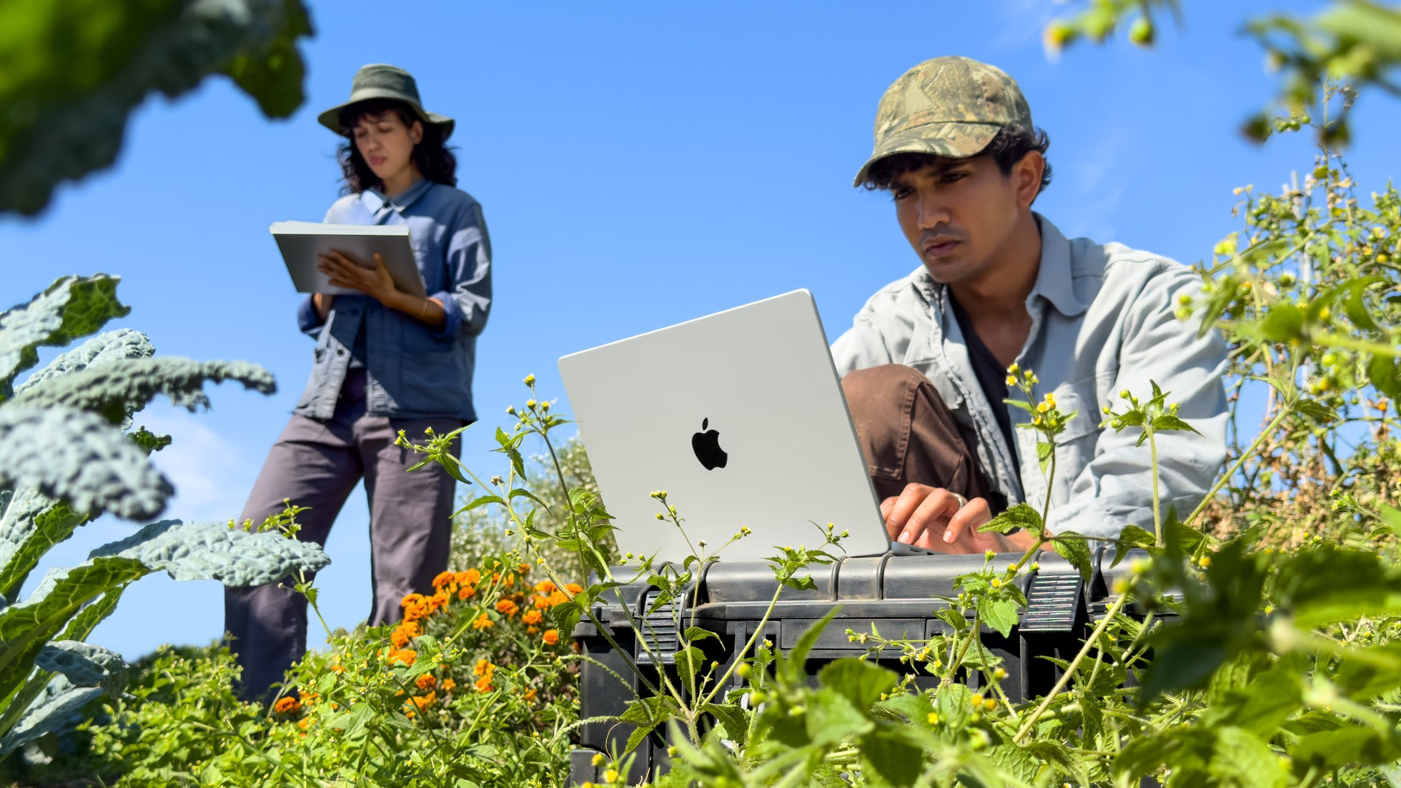 Apple MacBook Pro 14-inch M6 being used outdoors in a field