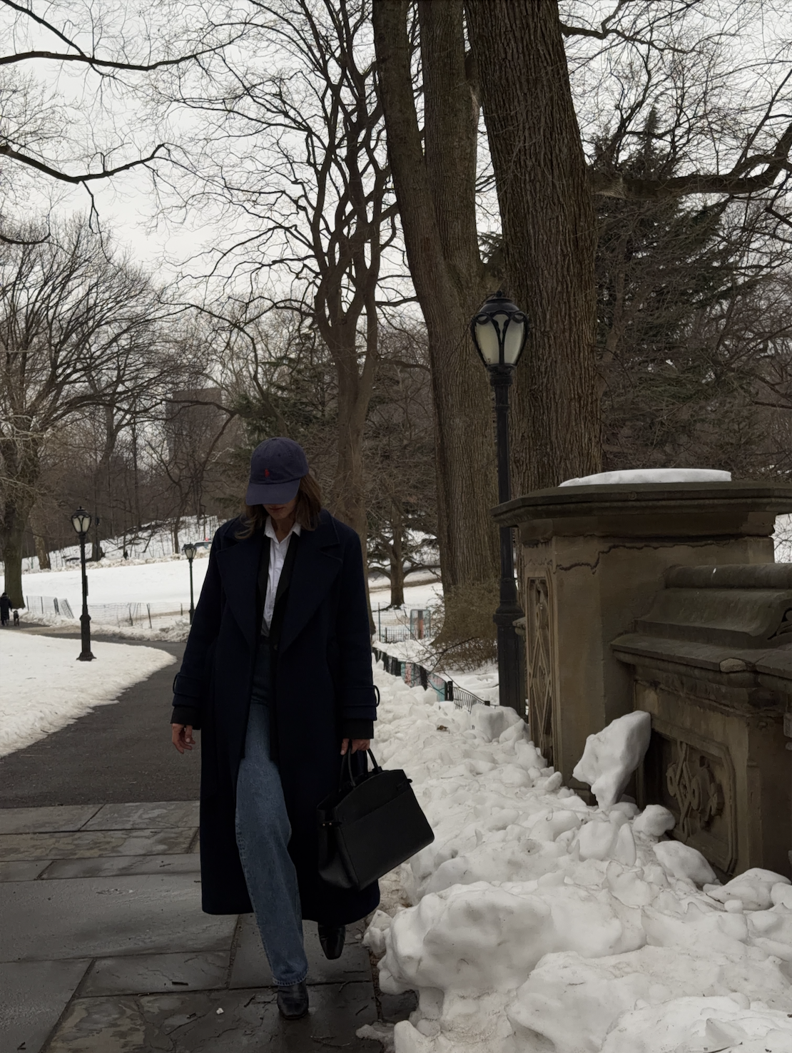 Kathryn Zahorak wearing baseball hat, coat, jeans, boots, black bag in new york city 