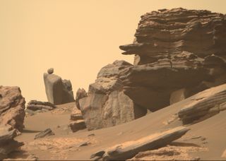 Mars rover Perseverance photo of snake-head rock and round boulder.