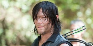 Daryl in the woods with his crossbow