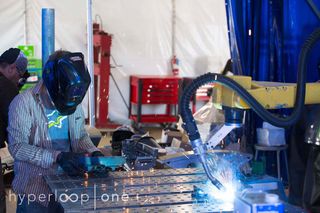 A welding robot works on a construction project at the Hyperloop One headquarters in Los Angeles.