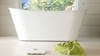 Fitbit Aria Wi-Fi Smart Scale review: the scale shown in a white bathroom
