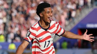 Malik Tillman sticks his tongue out after scoring during a United States Men's National Team soccer game.