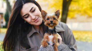 Woman looking happy with tiny terrier