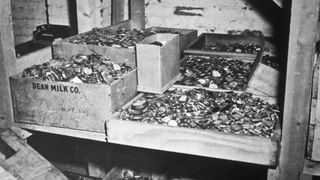 Here we see at least nine large open boxes filled with gold coins and jewelry that was collected by the Nazis from their victims. These were found in a cave adjoining the Buchenwald concentration camp.